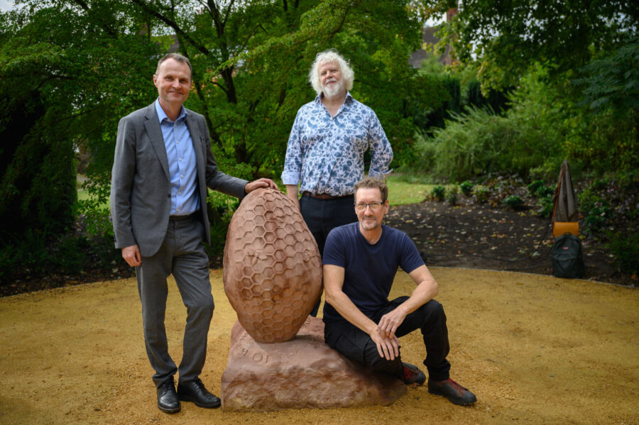 Professor Adam Tickell, Mark Noad of Lettering Arts Trust, and Dan Meek with the new sculpture.